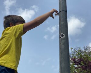 A child is installing a tube sensor to measure the air quality.